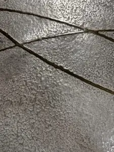 Eine stilvolle Wandfläche zeigt metallische Spachteltechnik mit flüssigem Metall, ideal für kreative Möbelgestaltung. Rezept: Unikat