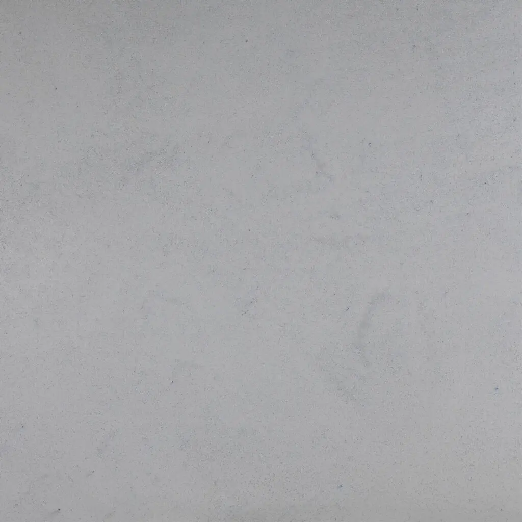 Eine elegante, graue Wand im Wohnzimmer zeigt die hochwertige Marmorputz-Oberfläche von Einhornwerke.