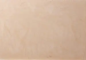 Die Wand zeigt eine gleichmäßige Oberflächentextur in warmem Farbton, ideal für schöne Wandgestaltung.