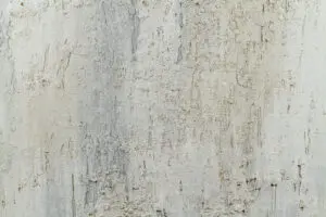 Die Wand zeigt eine kreative Oberflächengestaltung mit STUCCORINO® Goldglimmer, ideal für stilvolle Wohnzimmer. Rezept: Sparkle STUCCORINO ® 0,1 Farbtöne 0802 + 0203 + 1020 + 9020 + Goldglimmer grob