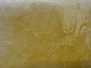 Die Wand zeigt eine kunstvolle Wandgestaltung mit VENEZIANO-Dolce-Streichputz in warmen Erdtönen von Einhornwerke.