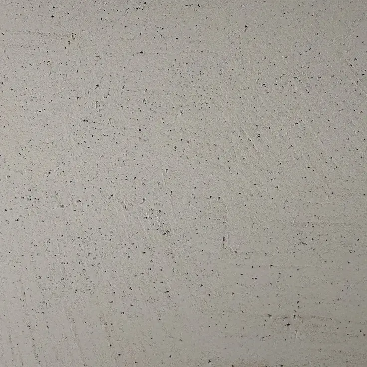Die Bodenbeschichtung in Betonoptik zeigt ein graues, strukturiertes Muster, ideal für moderne Wandgestaltung im Wohnzimmer.