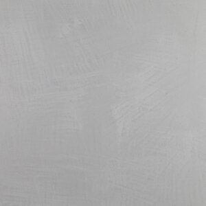 Eine glatte graue Wand zeigt die elegante Textur von MARMOREA Kalkputz für kreative Wandgestaltung.