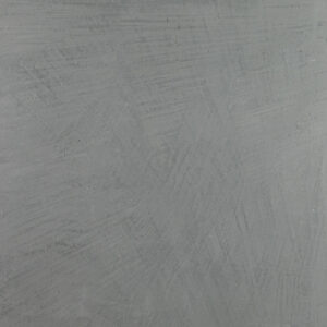 Die graue Wand zeigt eine elegante Textur aus MARMOREA-Kalkputz, ideal für kreative Wandgestaltung im Wohnzimmer.