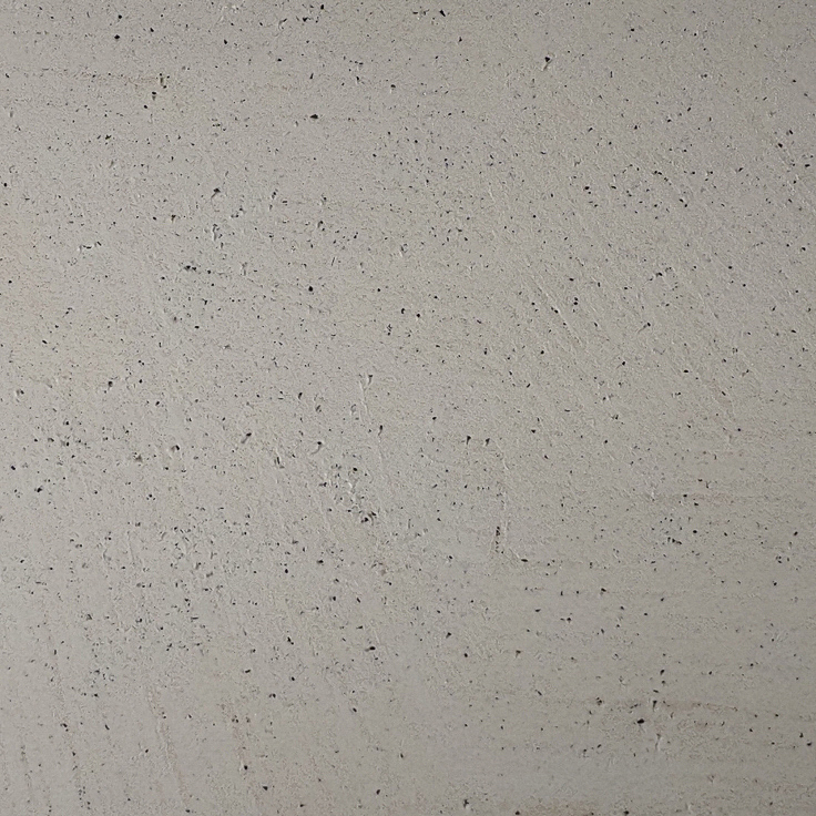 Die Bodenbeschichtung in Betonoptik zeigt ein graues, strukturiertes Muster, ideal für moderne Wandgestaltung im Wohnzimmer.